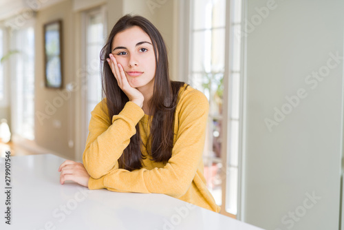 Free Download Beautiful young woman wearing yellow sweater thinking looking tired and bored with depression problems with crossed arms. - GFXLoad