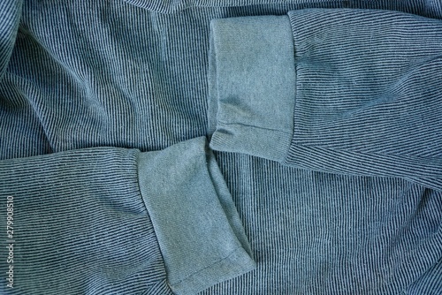 two gray wool sleeves on a piece of old clothes