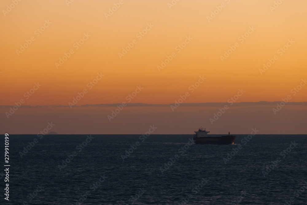 Ship sailing in the Mediterranean sea at sunset