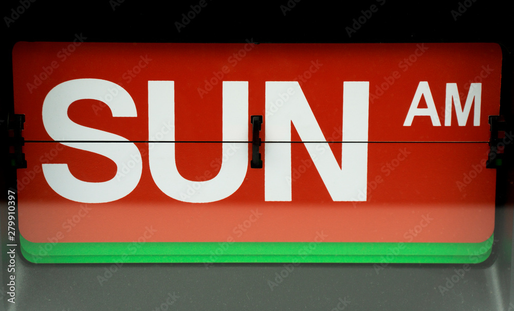 Close-up Flip clock alphabet Sunday on red background, Time concept. Close-up Flip clock alphabet Sunday on red background, Time concept.