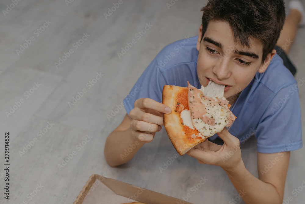 young man eating pizza at home, fast food young man eating pizza at home, fast food