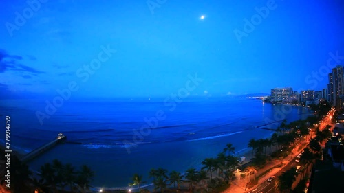 Waikiki Beach with Kalakaua Avenue in moonlight, Hawaii photo