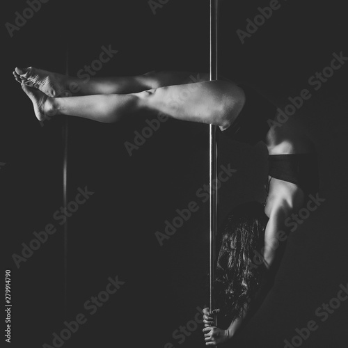 silhouette of pole dancer woman in action.