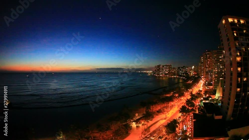 Waikiki Beach with Kalakaua Avenue at night, Hawaii photo