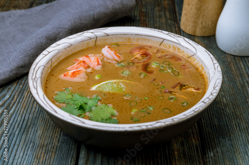 Tom Yam soup on blue wood table