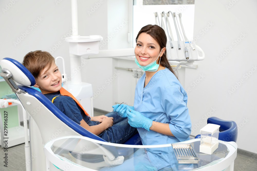 Professional dentist and little boy in clinic Professional dentist and little boy in clinic