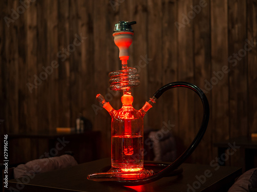 Beautiful glass hookah on the table in the bar. photo