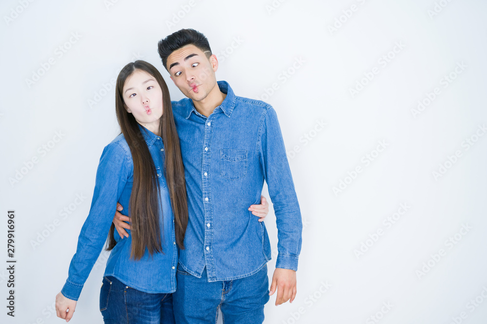 Beautiful young asian couple over white isolated background making fish face with lips, crazy and comical gesture. Funny expression. Beautiful young asian couple over white isolated background making fish face with lips, crazy and comical gesture. Funny expression.
