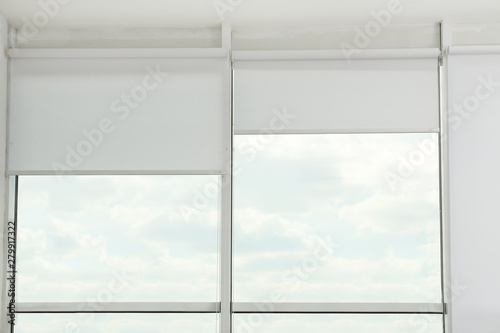 Large window with open roller blinds indoors