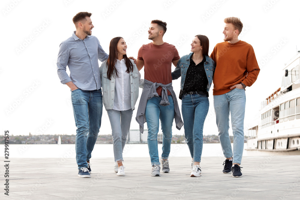 Group of happy people spending time together at promenade Group of happy people spending time together at promenade