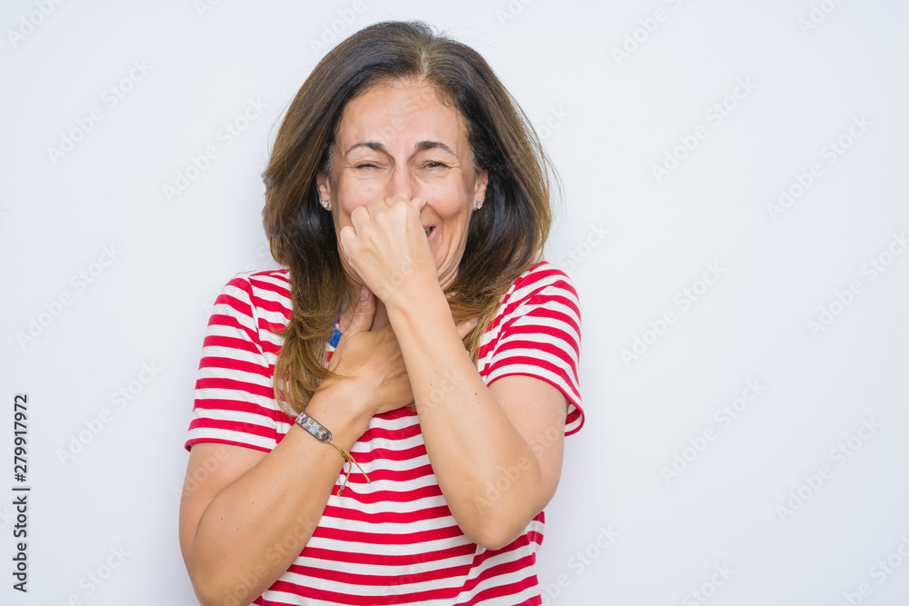 Middle age senior woman standing over white isolated background smelling something stinky and disgusting, intolerable smell, holding breath with fingers on nose. Bad smells concept. Middle age senior woman standing over white isolated background smelling something stinky and disgusting, intolerable smell, holding breath with fingers on nose. Bad smells concept.