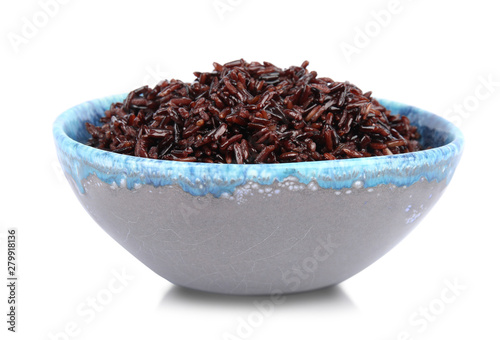 Bowl with delicious cooked brown rice on white background