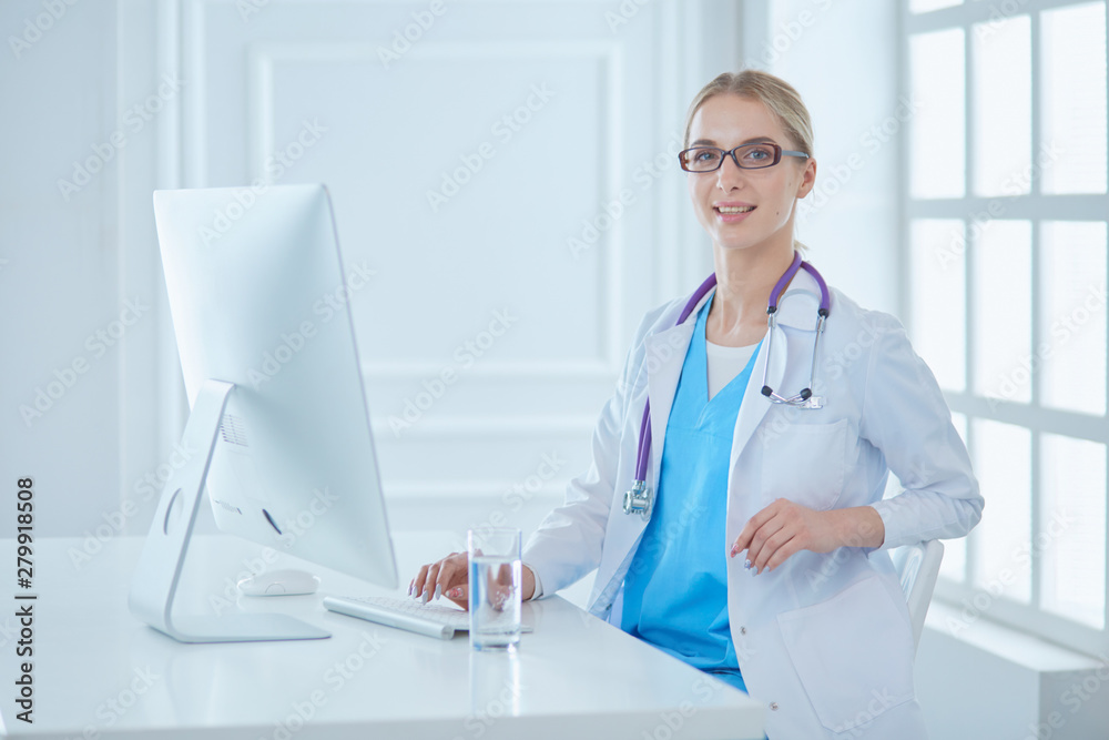 Portrait of young female doctor sitting at desk in hospital Portrait of young female doctor sitting at desk in hospital