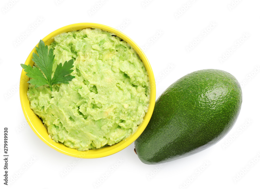 Bowl of tasty guacamole with basil and whole avocado on white background, top view Bowl of tasty guacamole with basil and whole avocado on white background, top view