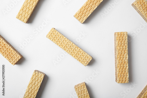 Flat lay composition with delicious crispy wafers on white background