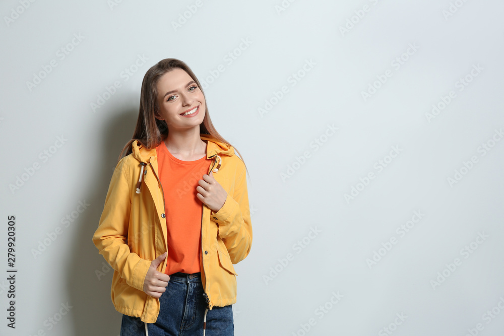 Young woman wearing blank t-shirt on light background. Mockup for design Young woman wearing blank t-shirt on light background. Mockup for design