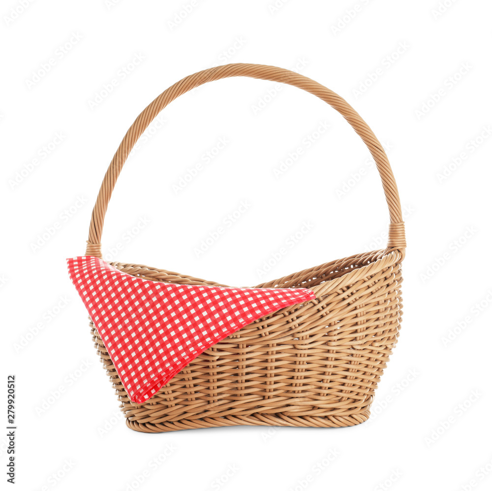 Wicker picnic basket with checkered tablecloth on white background Wicker picnic basket with checkered tablecloth on white background