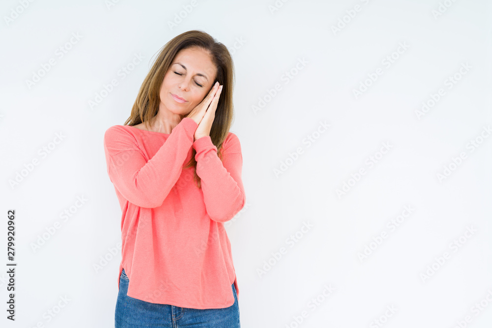 Beautiful middle age woman over isolated background sleeping tired dreaming and posing with hands together while smiling with closed eyes. Beautiful middle age woman over isolated background sleeping tired dreaming and posing with hands together while smiling with closed eyes.