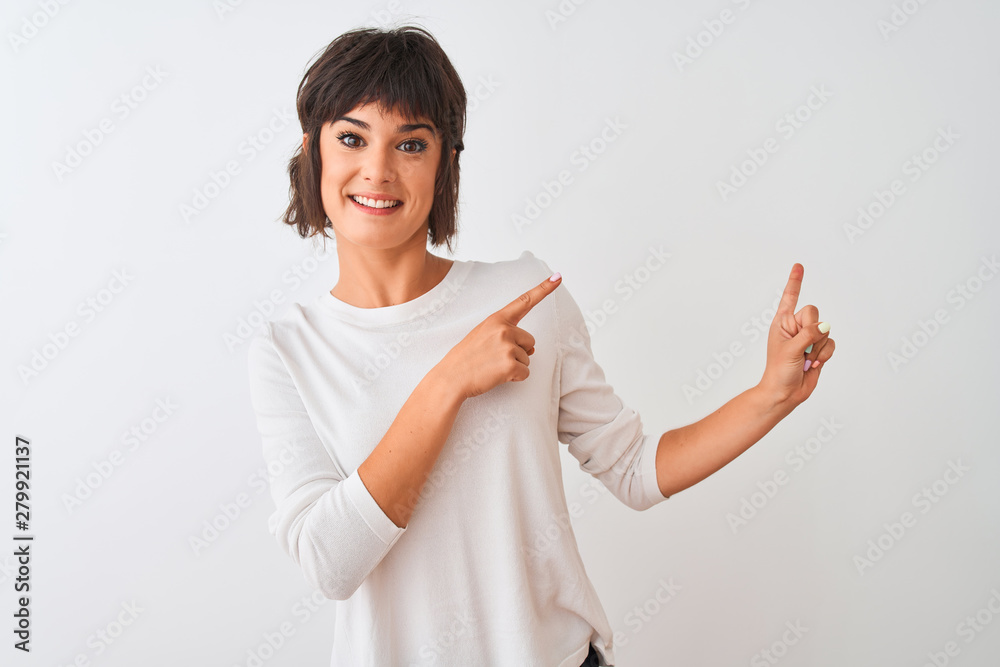 Young beautiful woman wearing casual t-shirt standing over isolated white background smiling and looking at the camera pointing with two hands and fingers to the side. Young beautiful woman wearing casual t-shirt standing over isolated white background smiling and looking at the camera pointing with two hands and fingers to the side.