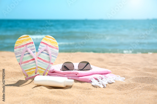 Set of different beach objects on sand near sea. Space for text