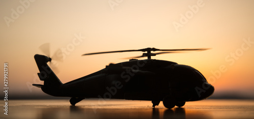 silhouette of military helicopter at sunset. Artwork decoration.