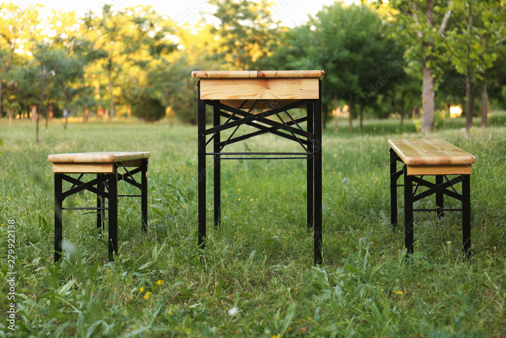 Wooden picnic table with benches in park Wooden picnic table with benches in park