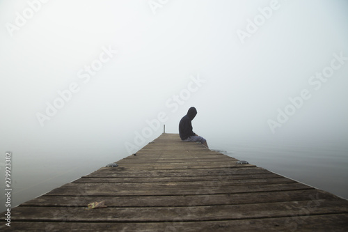 Fotografie, Obraz Person Sitting on Dock Alone