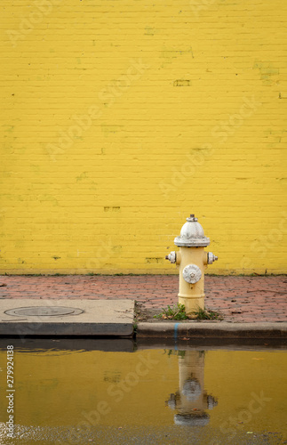 Yellow Brick Wall with Fire Hydrant on Flooded Street