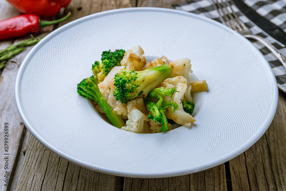 broccoli fried with onions on wooden background broccoli fried with onions on wooden background