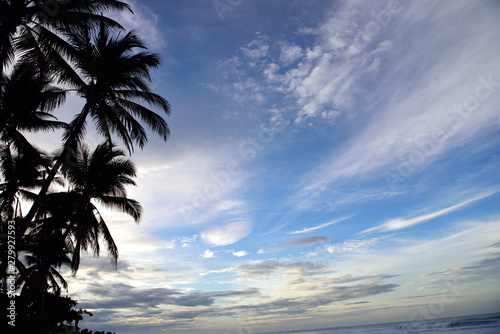 Tropical sunrise and sky, coconut trees and surf, El Salvador