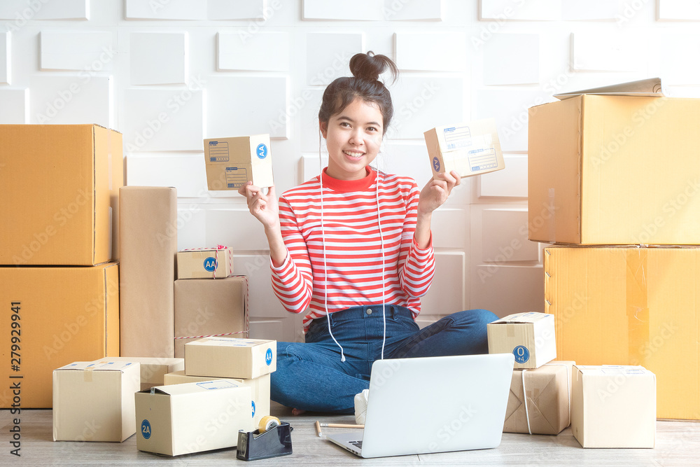 Asian women at the office of the online shopping business in the home office. Start a business, a business entrepreneur. SME, concept of online business Asian women at the office of the online shopping business in the home office. Start a business, a business entrepreneur. SME, concept of online business