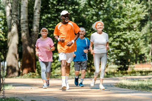sportive multicultural and senior men and women running in park © LIGHTFIELD STUDIOS