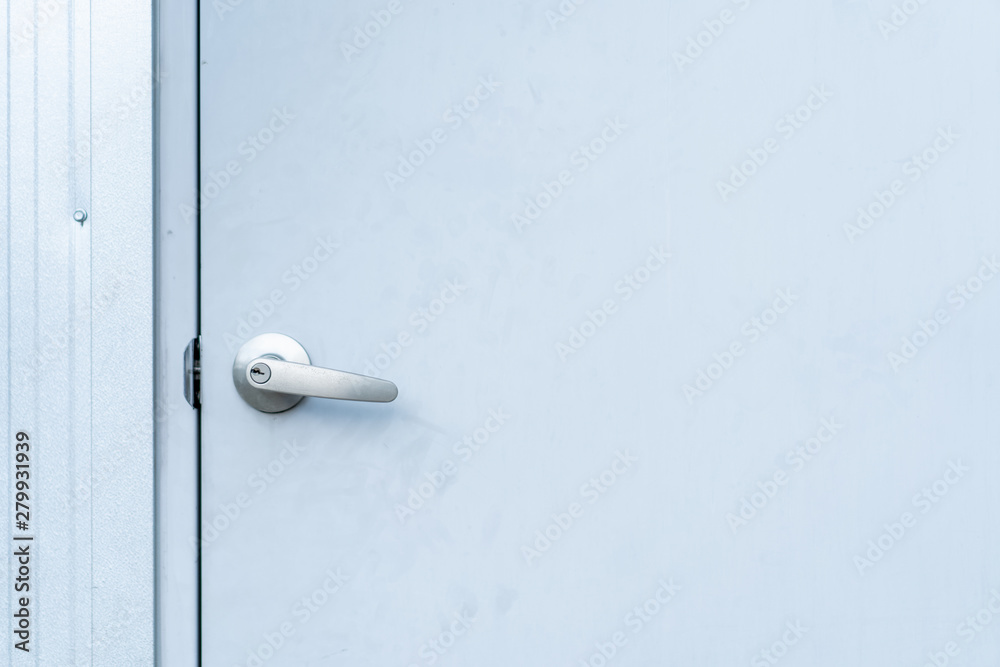 Metal door knob, door handle, in metal door close up.