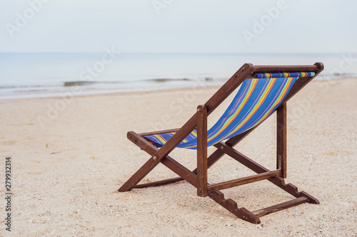 Vintage wooden bed at the beach with copy space. Concept of vacation, leisure, holiday and relaxing. Processed in vintage color tone © DG PhotoStock
