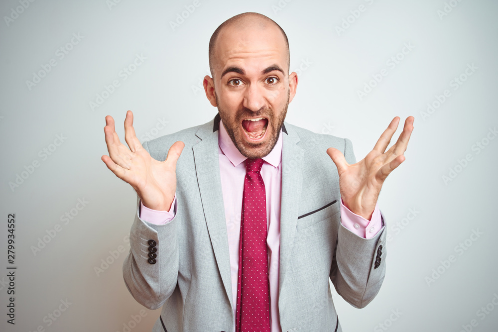 Young business man wearing suit and purple tie over isolated background celebrating crazy and amazed for success with arms raised and open eyes screaming excited. Winner concept Young business man wearing suit and purple tie over isolated background celebrating crazy and amazed for success with arms raised and open eyes screaming excited. Winner concept
