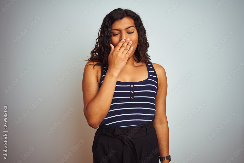 Transsexual transgender woman wearing striped t-shirt over isolated white background bored yawning tired covering mouth with hand. Restless and sleepiness.