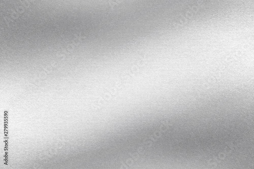 Glowing polished silver wave steel panel, abstract texture background