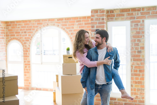 Young couple moving to a new house, boyfriend giving a piggy back ride to girlfriend, very happy and cheerful for new apartment © Krakenimages.com