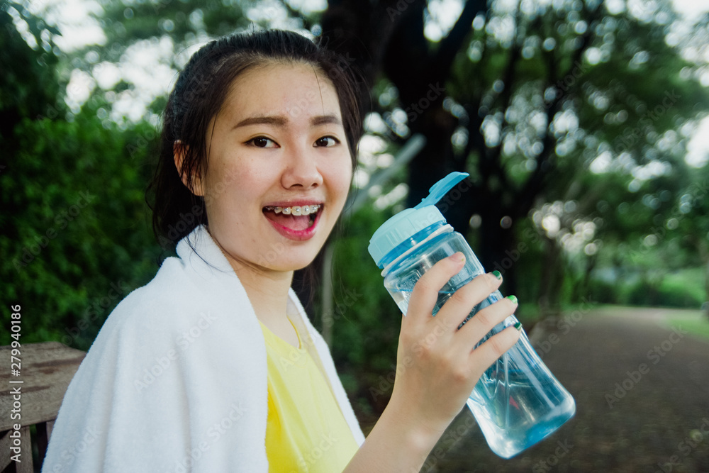 Pretty young asian girl taking a break in the park in the morning. Fresh and healthy lifestyle for teenager. Pretty young asian girl taking a break in the park in the morning. Fresh and healthy lifestyle for teenager.