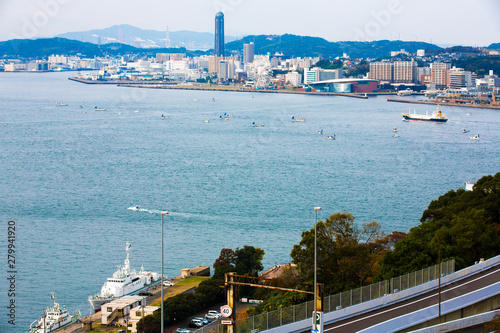 Kitakyushu, Japan - November 20, 2016 :Views of the island of Honshu, Osaka, Japan, a large port city and a commercial center, viewed from Kanmon strait and Kanmonkyo Bridge. photo