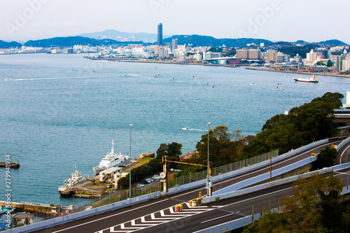 Kitakyushu, Japan - November 20, 2016 :Views of the island of Honshu, Osaka, Japan, a large port city and a commercial center, viewed from Kanmon strait and Kanmonkyo Bridge. photo