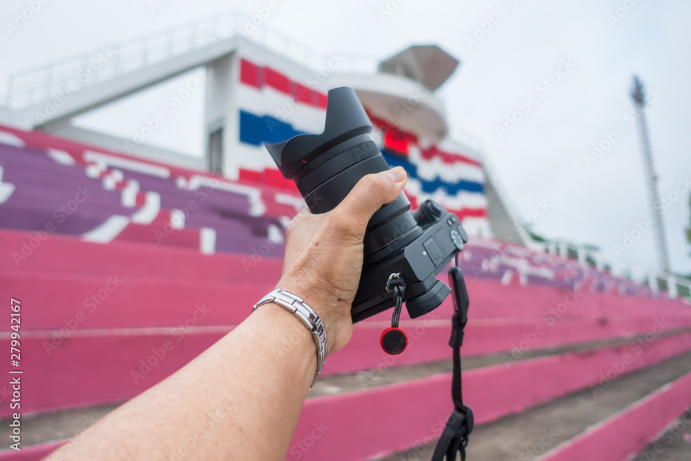 Fototapeta premium Male hand holding a digital camera.