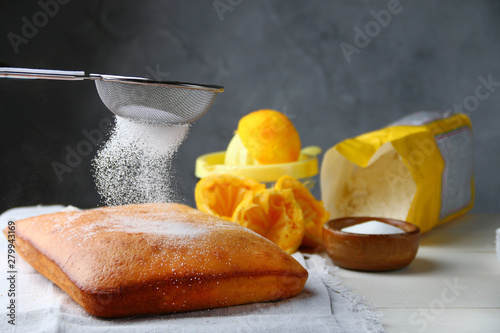 orange cake or bread with ingreients on table