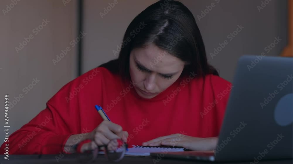 Concept of creative crisis. Upset girl pull out a sheet with writed ideas from a notebook. Concept of creative crisis. Upset girl pull out a sheet with writed ideas from a notebook.