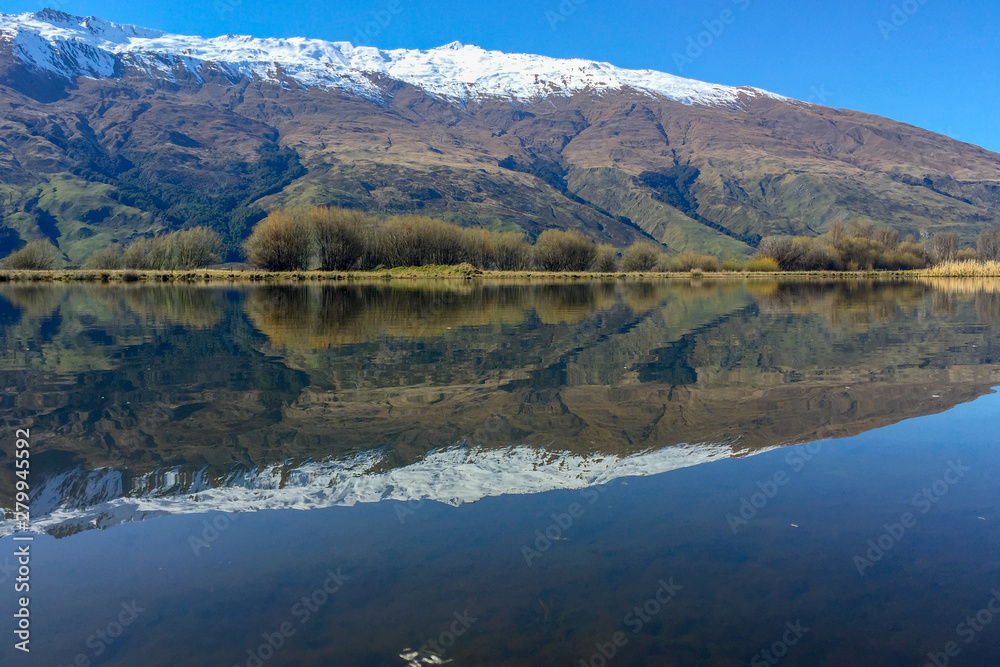 Snow capped Southern Alps overlooking beautiful lake scenes in the South Island New Zealand Snow capped Southern Alps overlooking beautiful lake scenes in the South Island New Zealand