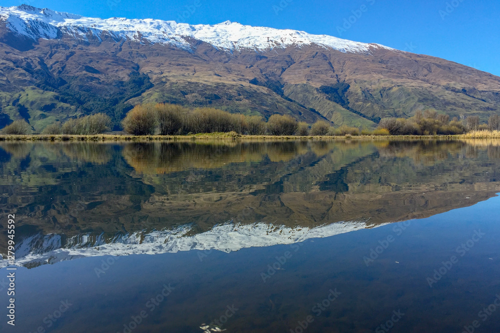 Snow capped Southern Alps overlooking beautiful lake scenes in the South Island New Zealand