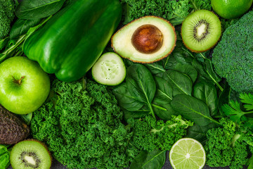 Selection of healthy green food fresh vegetables and fruit. Concept of green color, clean eating, vegetarian and vegan food and cuisine, lifestyle, diet, and fitness