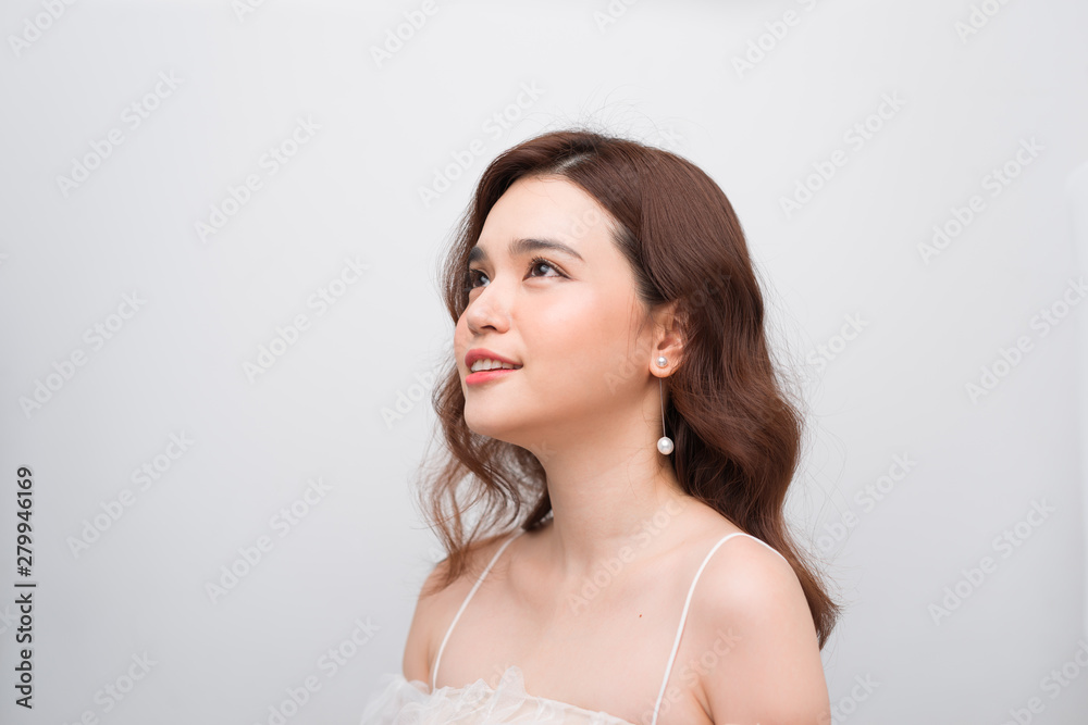 Beautiful smiling young asian woman with clean, fresh, glow, and perfect skin in white dress Beautiful smiling young asian woman with clean, fresh, glow, and perfect skin in white dress