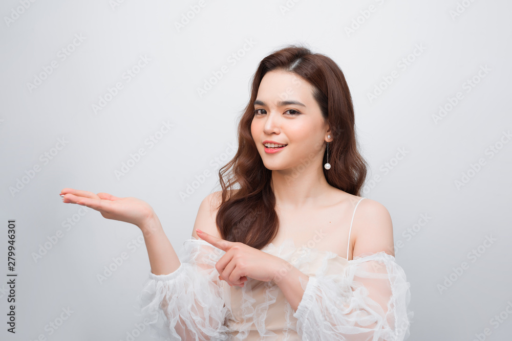 Gorgeous woman showing goods, product. It use for advertisement Gorgeous woman showing goods, product. It use for advertisement