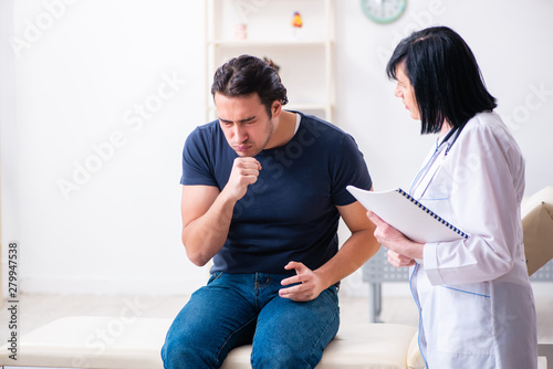 Young male patient visiting aged female doctor